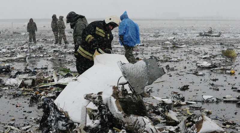 Russian Emergency Ministry employees investigate the wreckage of a crashed plane at the Rostov-on-Don airport, about 950 kilometers (600 miles) south of Moscow, Russia Saturday, March 19, 2016. A Dubai airliner crashed and caught fire early Saturday while landing in strong winds in the southern Russian city of Rostov-on-Don, officials said. (AP Photo)